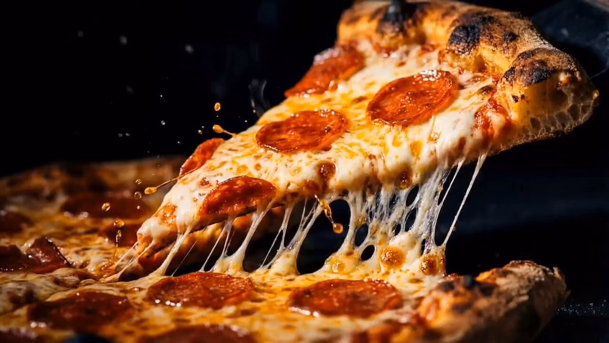 A pizza pulled apart with stretching cheese
